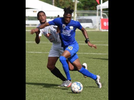 
Molynes United talisman Nicholas Nelson tries to shield the ball from Mount Pleasant’s James Liston during their Jamaica Premier League game last season.
