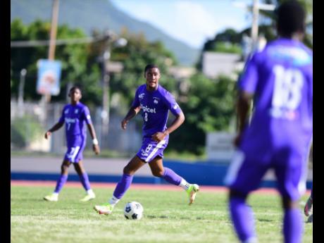 
Kingston College’s Christopher Pearson travels with the ball during his team’s ISSA/Digicel Manning Cup quarter-final game against Excelsior High School at the Ashenheim Stadium in St Andrew, Jamaica, on Saturday, December 18, 2021. 