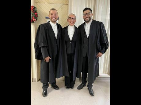 Jacob (left) and Luke Phillips pose with their mother, Queen’s Counsel Sandra Minott-Phillips, who called both of them to the Bar last Thursday during a ceremony at the Supreme Court in Kingston.
