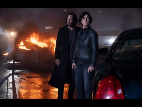  Keanu Reeves (left) and Carrie-Anne Moss in a scene from ‘The Matrix Resurrections’.