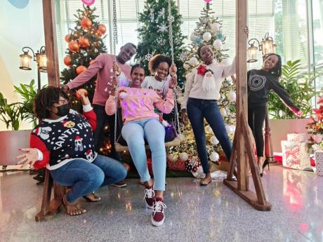 ‘Ugly Christmas sweaters look better when we wear them together,’ chanted the Digicel team of (from left) Dennecia Hector, billing analyst; Courtney Walters, implementation manager, Digicel Business; Christine Suragh, director of human resources; Daena