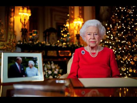 Britain's Queen Elizabeth II records her annual Christmas broadcast in Windsor Castle, Windsor, England. The photograph at left shows The Queen and Prince Philip taken in 2007 at Broadlands to mark their Diamond wedding anniversary. 