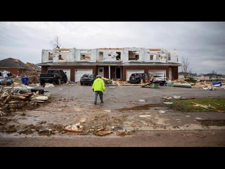 Residents of homes in the neighbourhood off Creekwood Avenue in Bowling Green, Kentucky, assess the damage of their properties after a tornado tore through in the early hours of Saturday, December 11. Storms swept through Bowling Green, Kentucky, near the 