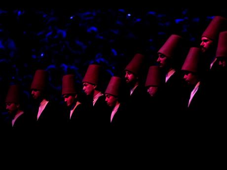 7. Whirling dervishes of the Mevlevi order perform during a Sheb-i Arus ceremony in Konya, central Turkey.