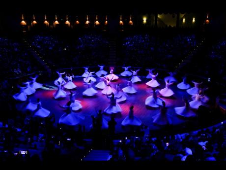 1. Whirling dervishes of the Mevlevi order perform during a Sheb-i Arus ceremony in Konya, central Turkey.