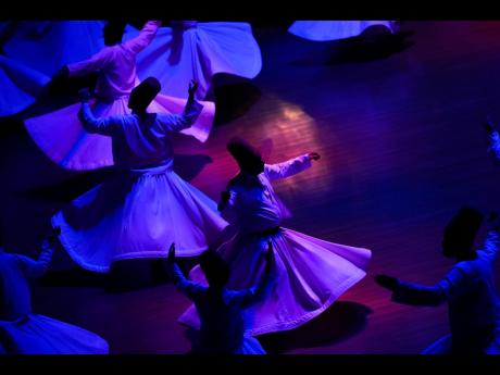 6. Whirling dervishes of the Mevlevi order perform during a Sheb-i Arus ceremony in Konya, central Turkey.