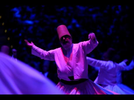 3. Whirling dervishes of the Mevlevi order perform during a Sheb-i Arus ceremony in Konya, central Turkey. Every December the Anatolian city hosts a series of events to commemorate the death of 13th-century Islamic scholar, poet, and Sufi mystic Jalaladdin