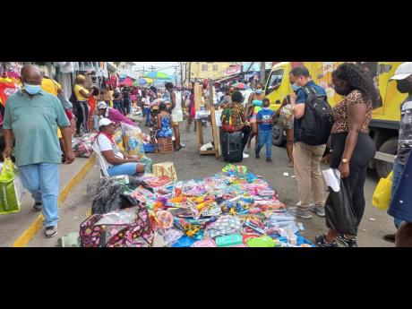 Shoppers viewing wares on sale during Grand Market in Linstead, St Catherine, on Christmas Eve.