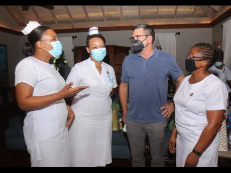 Cornwall Regional Hospital’s nurses Petrica Gordon, Maurice Dyer, and Annette Wright Bulgin share conversation with Mark Hart (second right), Caribbean Producers Jamaica executive chairman, while at the Doctor’s Cave Bathing Club ‘Honouring Our Nurse