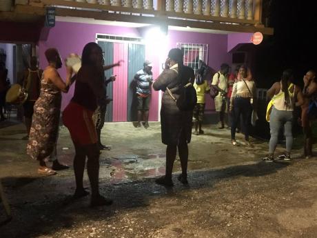 Residents of Clifton, Hanover, celebrating the safe return of 27-year-old Chaleen Evans yesterday after she had been missing for five days.