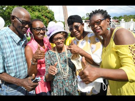 Iris Coley (centre) is joined in a celebratory moment by her children (from left) Maurice Coley, Carmen Bolt, Heather Jackson and Ruth Campbell at her Favorite Avenue home in Three Oaks Gardens, St Andrew.