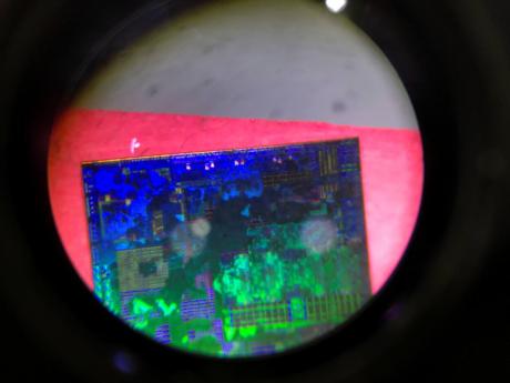 A Chinese microchip is seen through a microscope at the booth for the Tsinghua Unigroup project, during the 21st China Beijing International High-Tech Expo in Beijing on May 17, 2018.