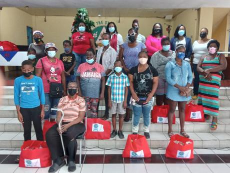 Parents from the Ministry of Education Quality Education Circle pose for a photo after receiving their care packages on Tuesday, December 21.