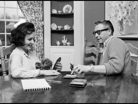 Allen Ludden and his wife Betty White plays a game of cards in their home in Westchester, New York on April 29, 1965. 