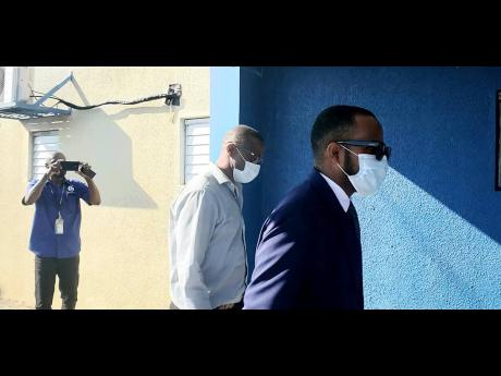 Westmoreland Central MP George Wright (left) and his attorney, Able-Don Foote, reporting to the Montego Bay Police Station.