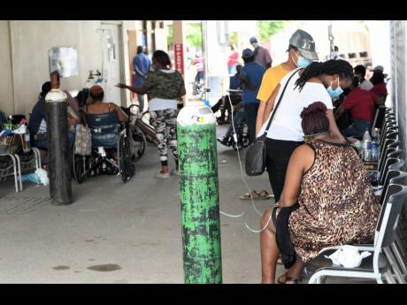 Patients on oxygen in a driveway at the University Hospital of the West Indies in St Andrew in late August, as the medical facility ran out of space to treat patients amid a surge in COVID-19 cases.