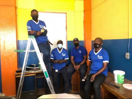 Members of The Gleaner team who assisted in the refurbishing of the reading room at St Aloysius Primary School. 
