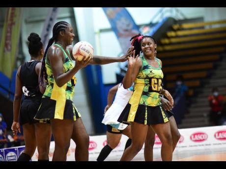 Sunshine Girls captain and top shooter  Jhaniele Fowler (left) celebrates with teammate Amanda Pinkney after scoring a goal during game two of the three-Test Sunshine Netball Series at the National Indoor Sports Centre.