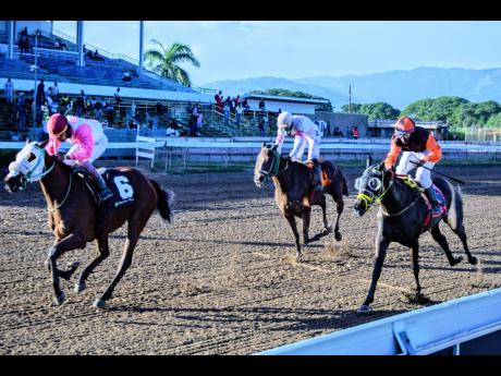 ITS A BOY (left), ridden by Anthony Thomas, wins the Jamaica Racehorse Trainers Association Trophy (Division One) over 7-1/2 furlongs at Caymanas Park on Saturday, December 18, 2021.
