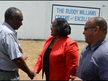 Minister with responsibility for Sports Natalie Neita Headley is greeted by former captain of the Melbourne Cricket Club (MCC), Ruddy Williams, during the opening of the Ruddy Williams Centre of Excellence at the MCC headquarters on Courtney Walsh Drive in
