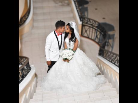The Bromfields lean in for a kiss at a stairwell at Montego Bay’s Holiday Inn Resort where they wed in July.
