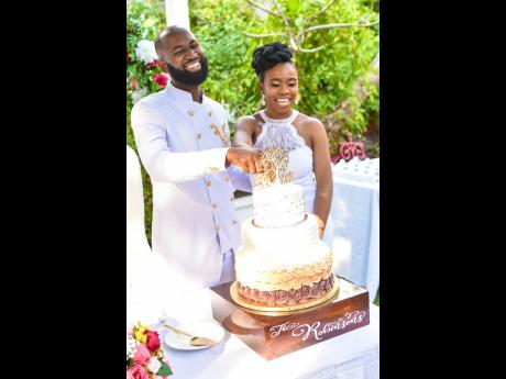 Dane and Kareen cut into their CeCe’s Cakery wedding cake.