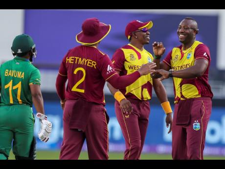 West Indies’ Andre Russell (right) celebrates with teammates Shimron Hetmyer and Dwayne Bravo after the run out of South Africa’s Temba Bavuma (left) during last year’s  Twenty20 World Cup.