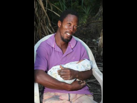 
Anthony Simpson of Carty Hill in James Hill, Clarendon, is all smiles as he relates the Christmas Eve events surrounding the birth of his twin daughter and son, Rochelle and Rasheed.