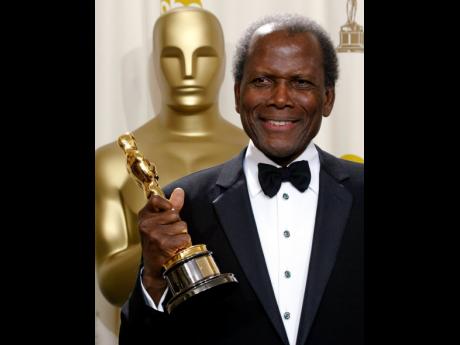  Sidney Poitier poses with his honorary Oscar during the 74th annual Academy Awards on March 24, 2002, in Los Angeles.  