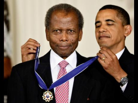 
Barack Obama, former president of the United States, presents the 2009 Presidential Medal of Freedom to Sidney Poitier during ceremonies in the East Room at the White House in Washington on, August 12, 2009. 