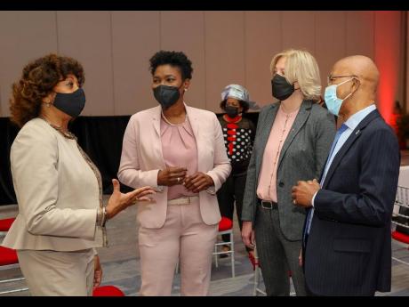 Diane Edwards (left), president of the Jamaica Promotions Corporation, makes a point as Audrey Tugwell Henry (second left), president and CEO, Scotia Group Jamaica; Anya Schnoor (second right), executive vice-president, Scotiabank Caribbean, Central Americ