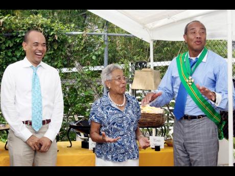 In this October 20, 2008, Gleaner photograph, Hyacinth Gloria Chen interacts with sons Wayne Chen (left) and Michael Lee-Chin at a reception. 