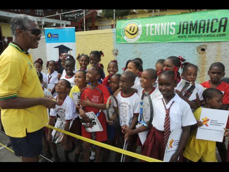 New Director of Tennis at Tennis Jamaica, Evan Williams, with students of Mannings Hill Primary School in 2014 during a function at the school.