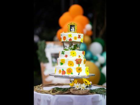 Stepping away from the traditional cake, designer Juliet Williams played with the wedding’s ‘rustic garden fantasy’ theme by adding flowers that matched the colour scheme. 