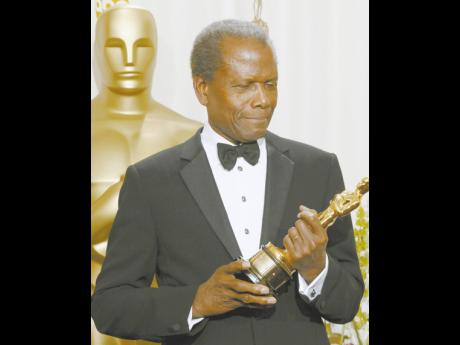 Sidney Poitier holds his honorary Oscar at the 74th annual Academy Awards in Hollywood March 24, 2002. Poitier received his award for his “extraordinary performances and unique presence on the screen and for representing the motion picture industry with 