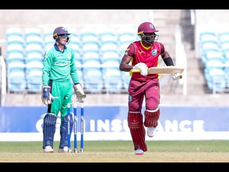 West Indies batsman Shamarh Brooks goes for a run as Ireland wicketkeeper, Lorcan Tucker, looks on during the first of three ODIs between the teams at Sabina Park on Saturday. 