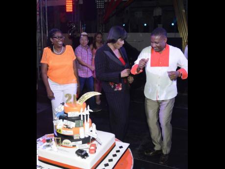 From left: Angela Brown Burke looks on as then Prime Minister Portia Simpson Miller dances with then Science, Technology, Energy and Mining Minister Phillip Paulwell at the latter’s birthday party in January 2016.