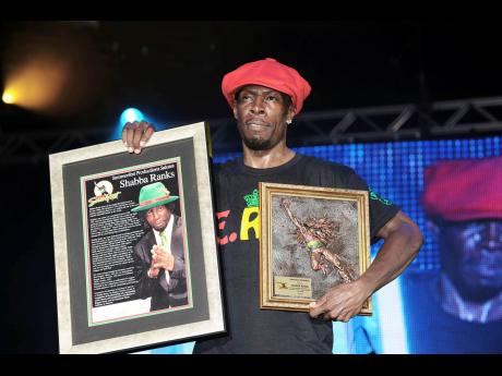 Shabba Ranks holds up the plaques which he was awarded at the 20th staging of Reggae Sumfest in 2012.