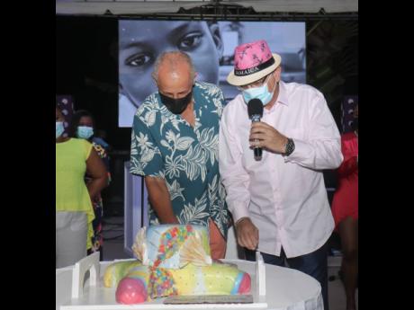 Glenn Lawrence (left), chief executive officer, Couples Resorts, is ready to cut the 16th anniversary cake with General Manager Pierre Battaglia, at Couples Sans Souci’s celebration on Friday. 