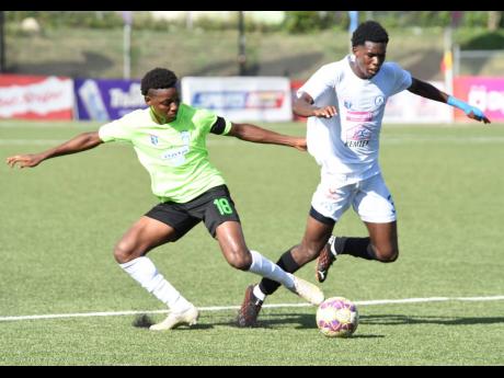Shaqueil Bradford (left) of Waterhouse and Mount Pleasant’s Ladale Ritchie in a keen tussle for the ball during a first leg semi-final match in the 2021 Jamaica Premier League season.