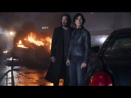 Keanu Reeves and Carrie-Anne Moss reprise their iconic roles as Trinity and Neo in ‘The Matrix Resurrections’.