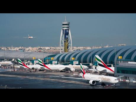 An Emirates jetliner comes in for landing at the Dubai International Airport in Dubai, United Arab Emirates, on December 11, 2019.