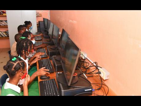 Students of the Brixton Hill Primary and Infant School in Clarendon using the new computers at the community access point (CAP), which opened at the school on Wednesday, January 19.