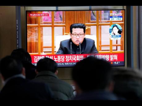 People watch a TV showing a file image of North Korean leader Kim Jong Un shown during a news programme at the Seoul Railway Station in Seoul, South Korea yesterday.