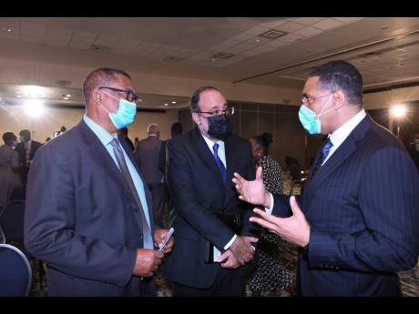 From left: Chairman of the National Leadership Prayer Breakfast Committee, Reverend Samuel McCook, and Opposition Leader Mark Golding in conversation with Prime Minister Andrew Holness at the 42nd annual National Leadership Prayer Breakfast held at The Jam