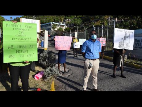 Disgruntled staff of the National Council on Technical, Vocational Education and Training and the Vocational Training Development Institute protest over unresolved issues relating to their employment at the gate of the Gordon Town Road, St Andrew-based cam