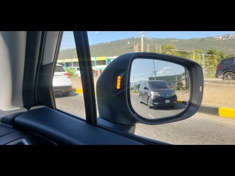 There is a light, in the side mirrors, that flashes whenever an object, in the driver’s blindspot, is located.  