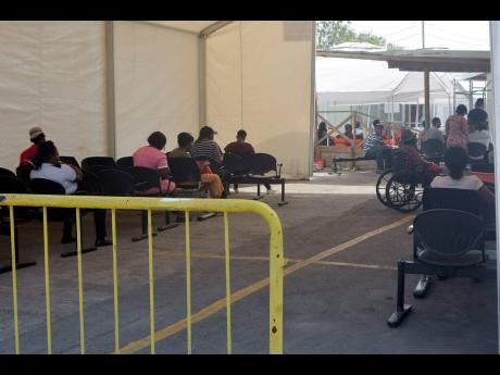 
This March 2020 photo shows patients sitting in the vicinity of the Accident and Emergency Department at the Cornwall Regional Hospital in St James.