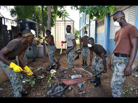 Members of the Jamaica National Service Corps helping to clean up the Boys’ Town Infant and Primary School in Kingston in February 2019 as part of a beautification project.