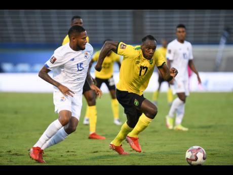 Jamaica’s Michail Antonio (right) powers past Panama’s Eric Davis Grajes during a Concacaf World Cup qualification football match at the National Stadium on Sunday, September 5, 2021.
